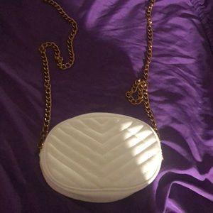 White crossbody bag with a gold chain